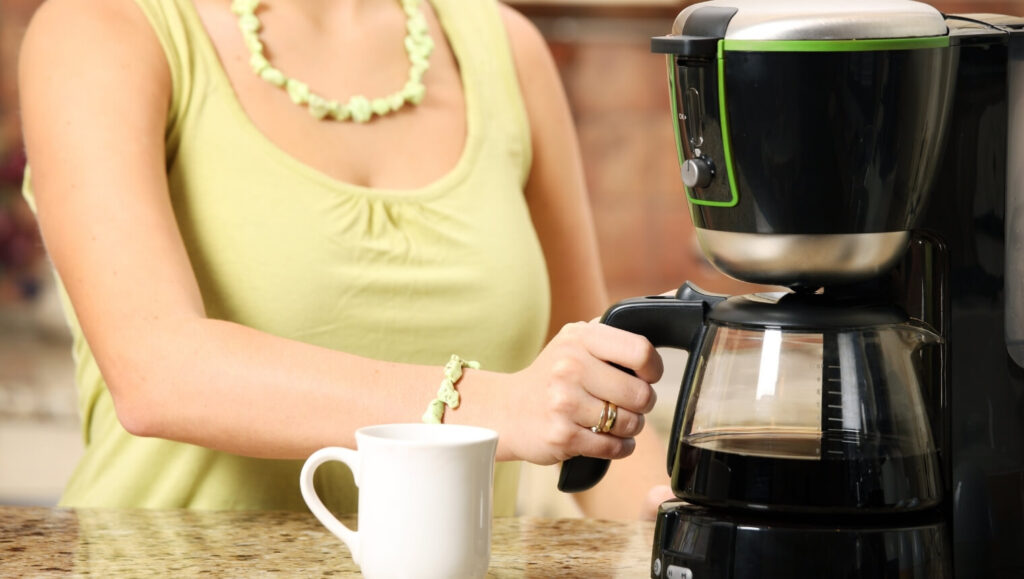 A young woman is preparing morning coffee for herself and her family