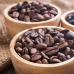 different types of coffee beans in wooden bowl
