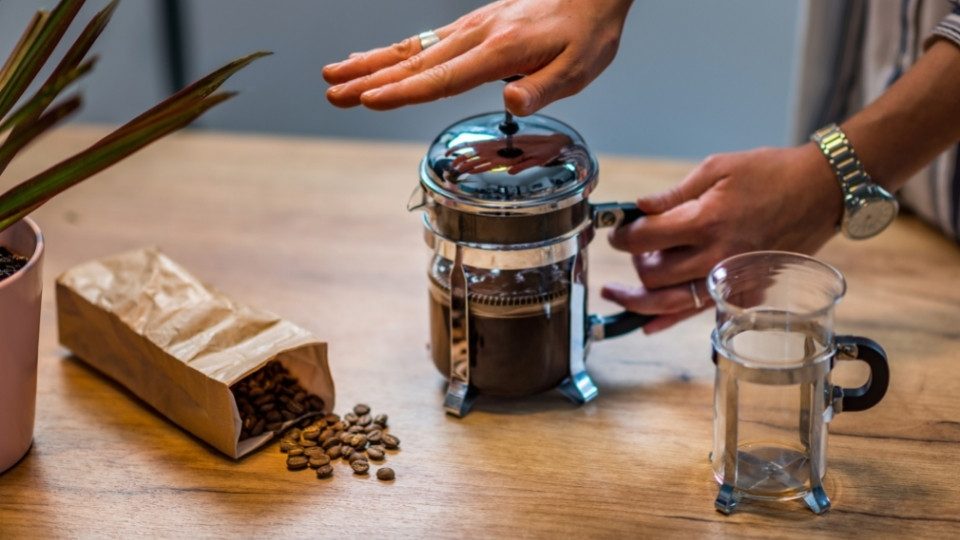 Man preparing espresso with a use of French Press