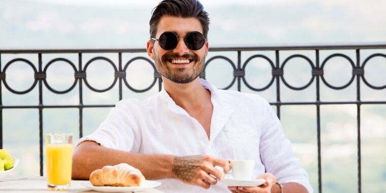 A man enjoying his morning espresso shot after his breakfast